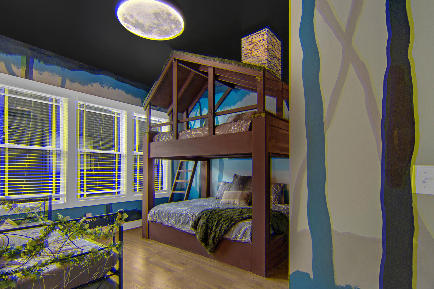 Children's bedroom with a wooden bunk bed and forest-themed wall mural.