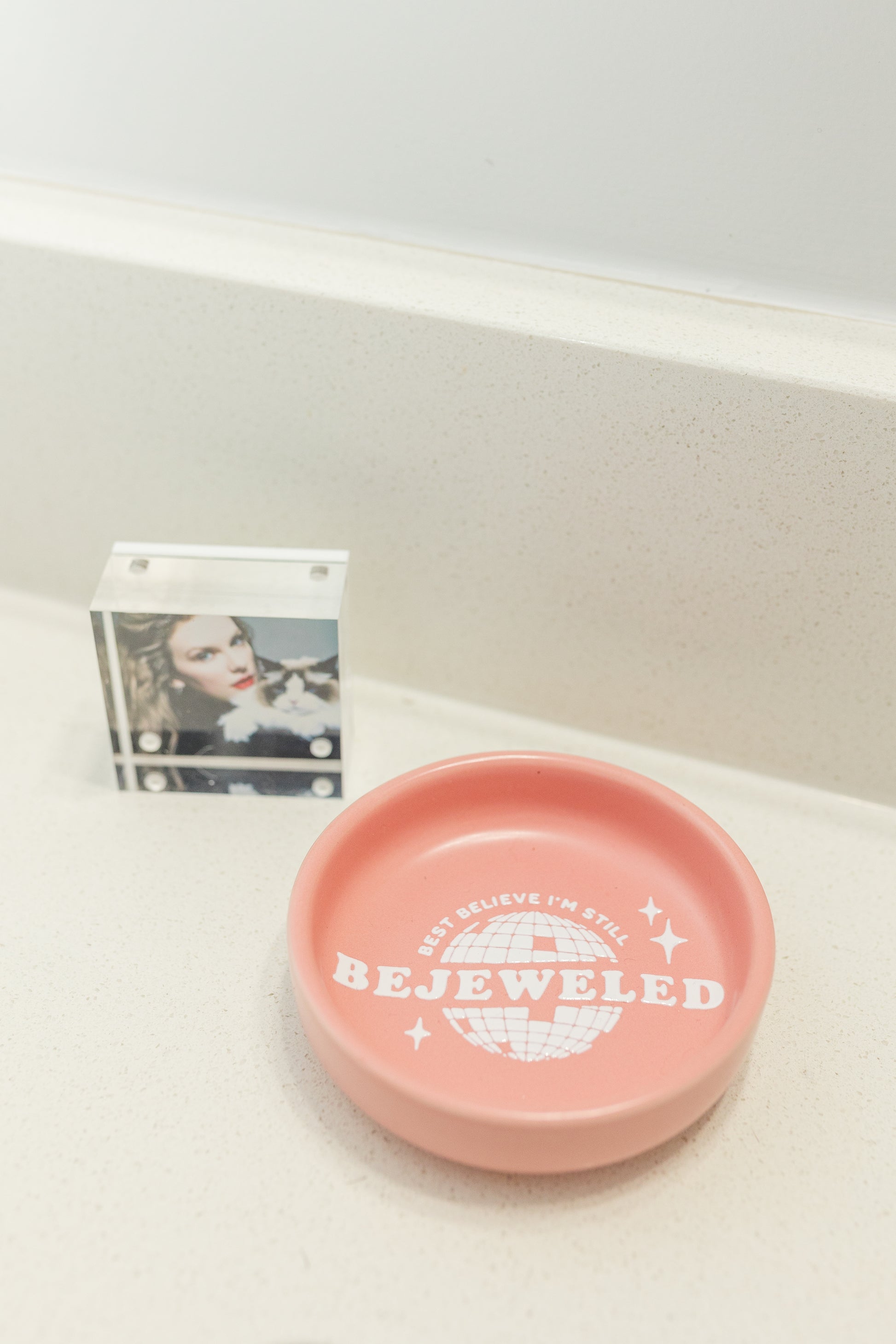 Pink dish with 'Bejeweled' text on a white surface